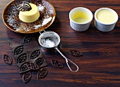 Souffle with chocolate flakes and icing sugar in sieve