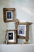 Three wooden photo frames on wall