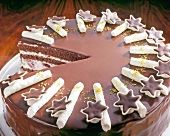 Close-up of chocolate cake with rolls and stars, step 3
