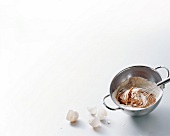 Cream and chocolate in bowl with whisk and egg shells, copy space