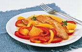 Nile perch with orange bell pepper on plate