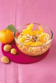 Winter cereal with orange and tangerine in glass bowl