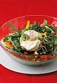 Close-up of bowl of peppers, rocket salad, camembert and onion on plate
