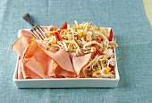 Sprout salad, smoked turkey breast slices in square dish