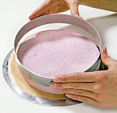 Close-up of hand removing cake ring, step 2