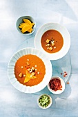 Gazpacho with mango in two bowls, overhead view