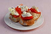 Pita bread with peppers and mozzarella on plate