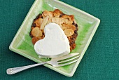 Almond chip cookies and heart shaped cream in serving plate