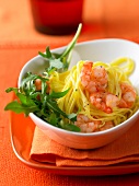 Close-up of bowl of shrimp pasta on orange dish