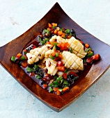 Spicy squid with peppers and black bean paste in serving dish