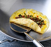 Vegetable-minced meat mixture kept on omelette in wok, step 4