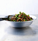 Lamb mince with peas, onions and turmeric in bowl, India