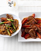 Duck with mie noodles and duck with plum stew on plates