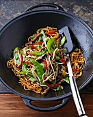 Stir-fried beef with noodles, mange tout and peppers