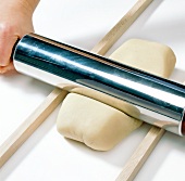 Close-up of dough being rolled with rolling pin, step 3