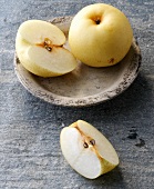 Halved and whole pears on plate