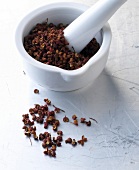 Sichuan peppercorns in mortar with pestle