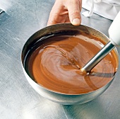 Close-up of chocolate-cream mixture being mixed with blender