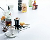 Various bottles of rum with hot chocolate in cups on white background