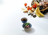 Basket with vegetables and spices on white background