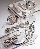 Variety of steel kitchen utensils on white background