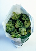Close-up of frozen broccoli florets in an open bag