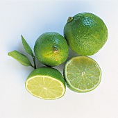 Close-up of whole lemons and lemon cut into half on white background