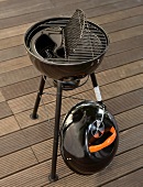 Round charcoal grill with lid opened