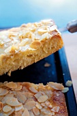Close-up of raise butter cake with almond flakes