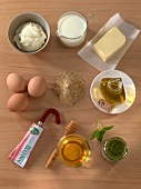 Cream, milk, butter, eggs and other ingredients for sauces and dips on wooden board