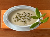 Pepper cream sauce with bay leaf in bowl 