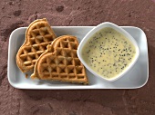 Waffles with white poppy chocolate sauce in serving dish