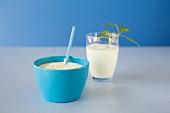 Yoghurt in blue bowl and butter milk in glass