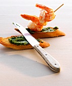 Two crostini with cashew pesto and prawns