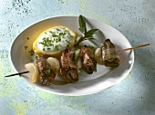 Chicken liver skewers with chive yogurt in hollowed lemon in serving dish