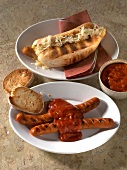 Hot dog with sauerkraut filling and grilled sausages with creole sauce on two plates