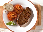 Steak, tomatoes and bread grilled in western style on plate
