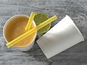 Fruit juice in glass with two straws