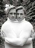 Portrait of two blonde men wearing white sweater, black and white