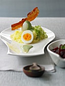 Eggs with herb mustard, beetroot, potato snow and bacon on serving dish