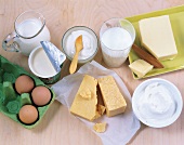 Close-up of glass of milk, curd, eggs and butter