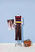 Knitted stripe tank top, blouse and trousers on mannequin