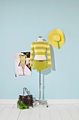 Green yellow striped cardigan with green shorts on mannequin and hat on side