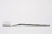 Silver toothbrush on white background