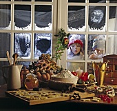 Children looking from outside through window at baking ingredients for Christmas cookies