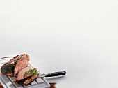 Smoked pork cheek, parsley, knife and board on white background, copy space