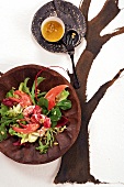 Winter salad with lobster, apricot kernel oil and pine nuts on plate