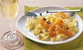 Chicory salad with orange pieces and walnut on plate