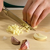 Garlic being diced with knife, step 3