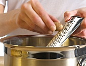 Nutmeg being scraped on grater, step 2